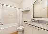 Bathroom #2 en suite full bathroom with tiled shower and tub. 