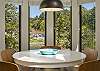 Dining table with 5 chairs and 4 beautiful floor to ceiling windows. 