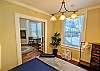 Queen bed with pocket doors looking into the living room. 