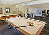 Game room with pool table, air hockey, foosball, board games, and Smart tv. 