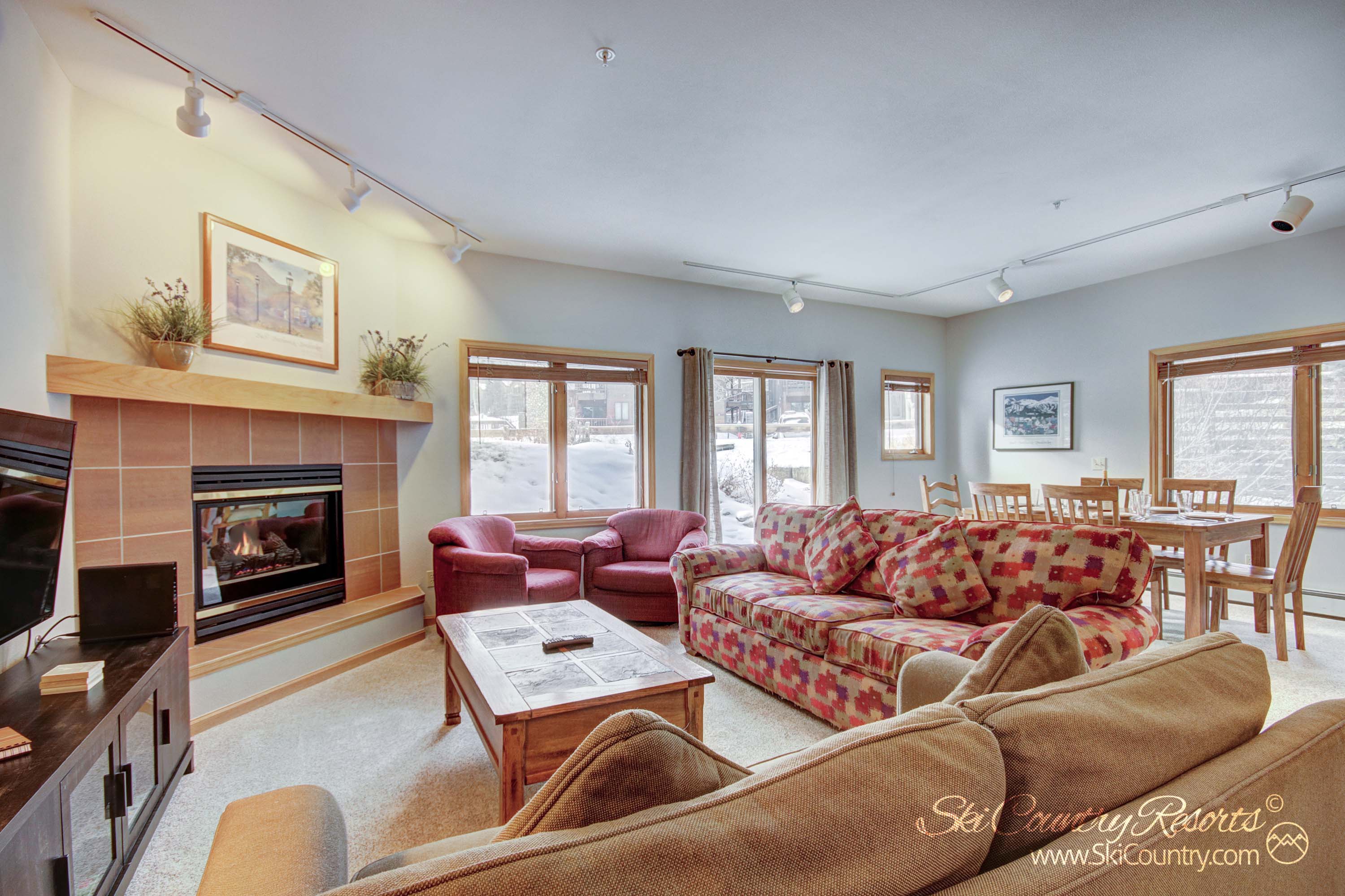 Get cozy on one of the two plush sofas & enjoy entertainment options on the the flatscreen TV. Or warm up by the inviting fireplace, nestled in one of the two neighboring side chairs while losing yourself in a captivating read or the outside views.
