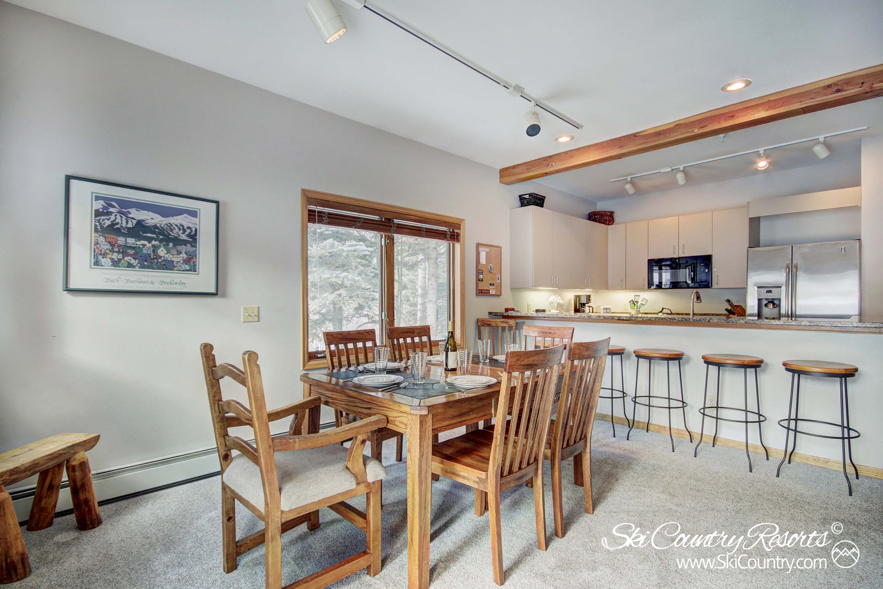 Gather around the wooden dining room table, comfortably seating six (w/ extra chair for 1). Enjoy meals together & engage in lively conversations while overlooking the open concept kitchen. 