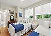 Secondary bedroom featuring a full-size bed and a twin bed.