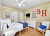 Secondary bedroom featuring a full-size bed and a twin bed.