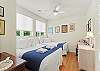 Secondary bedroom featuring a full-size bed and a twin bed.
