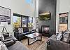 Main entry (middle level) living room, with modern, open kitchen, dining and living room. Living Room features gas fireplace, large SMART TV, and Wifi