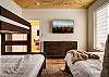 Bedroom with queen bed, and twin over double bunk bed. 