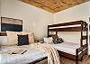 Bedroom with queen bed, and twin over double bunk bed. 