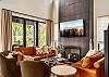 Main entry (middle level) living room, with modern, open kitchen, dining and living room. Living Room features gas fireplace, large SMART TV, and Wifi