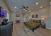Spacious one room condo has a king bed with tv, microwave, refrigerator, and coffee maker.