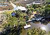 Exterior drone shot showing the house and canal