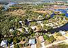 Exterior drone shot showing the house and canal