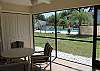 Covered patio with seating and views of the community pool