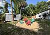 Back yard with fire pit, deck with BBQ and corn hole