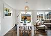 Dining area open to the living room with woodstove and Smart TV