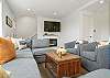Living room with electric fireplace, Streaming TV, open to dining room and kitchen with Bar seating. 