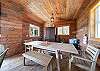 Outdoor living space with covered lounging furniture, streaming TV, dining area, open to back yard with BBQ. With uncovered sun deck for lounging