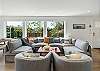 Living room with electric fireplace, Streaming TV, open to dining room and kitchen with Bar seating. 