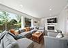Living room with electric fireplace, Streaming TV, open to dining room and kitchen with Bar seating. 