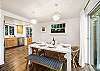 Dining table open to the living room with access to the front deck.