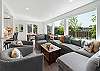 Living room with electric fireplace, Streaming TV, open to dining room and kitchen with Bar seating. 