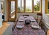 Dining room with additional bench seating, Ocean views, and access to the fenced yard area.