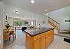 Fully equipped kitchen with breakfast bar, open to dining and living area with gas fireplace