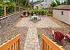 Back Courtyard with outdoor dining table and chairs, lounge chairs, and fenced yard. 