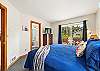 King bedroom with access to the back yard and deck, streaming TV, Master bath with Jacuzzi tub. 