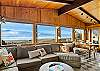 Mountain and ocean views from the open living space with smart TV, wood fireplace and comfy couch