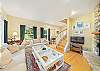 Living room with access to upstairs, double sided wood fireplace, Cable and Streaming TV 
