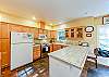 Spacious kitchen with ample counter space. Electric stove and automatic dishwasher