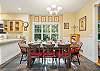 Open kitchen and dining area with window seating, and fireplace