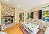 Living room with access to upstairs, double sided wood fireplace, Cable and Streaming TV 