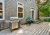 Gas BBQ on the back deck with large table, hot tub, umbrella