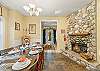 Wood burning double sided fireplace, dining table and open kitchen area.