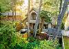 Lovely wooded area surrounds the partially fenced yard with hot tub off the back deck. 