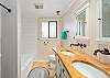 Main bath with double sinks and Shower/ Tub combination. 
