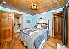 Master bedroom with queen bed and attached bath with walk in shower