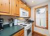 Fully equipped kitchen with breakfast bar, open to living room and dining room .
