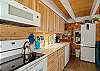 Kitchen with electric stove and oven, automatic dishwasher and microwave