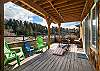 Lower deck with outdoor lounging area, Corn hole boards and Adirondack chairs.