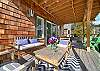 Lower deck with outdoor lounging area, Corn hole boards and Adirondack chairs.