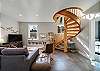 Beautiful craftsman spiral wood staircase to the lower living area, 2 bedrooms, full bath, wet bar, laundry room, foos ball table and access to lower deck. TV, Games, books and DVD player. 