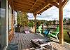 Lower deck with outdoor lounging area, Corn hole boards and Adirondack chairs.