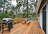 Back deck with picnic table. Perfect for puzzles, dominos etc. Adirondack chairs for lounging and gas BBQ for outdoor grilling. 