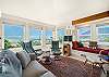 Oceanview living room with woodstove, streaming tv w/ basic channels, reading nook, electric piano. Access to deck with ocean view .