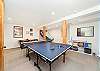 Downstairs game room with Ping pong table, Basketball game, Air Hockey, foos ball, and Large sectional couch, and mini fridge. 