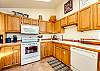 Fully equipped kitchen open to the dining room. 