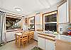 Downstairs small game/dining table in the kitchenette area (no appliances) with sink and gumball machine. 